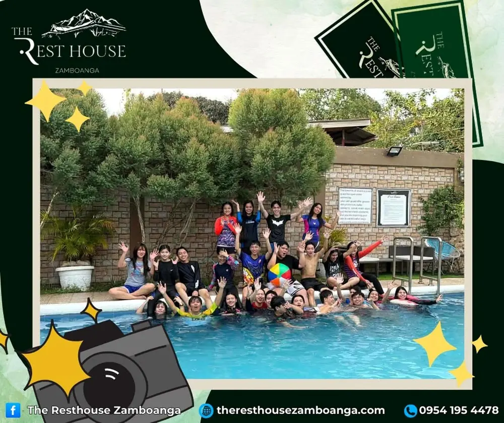A group of young people waving from the swimming pool