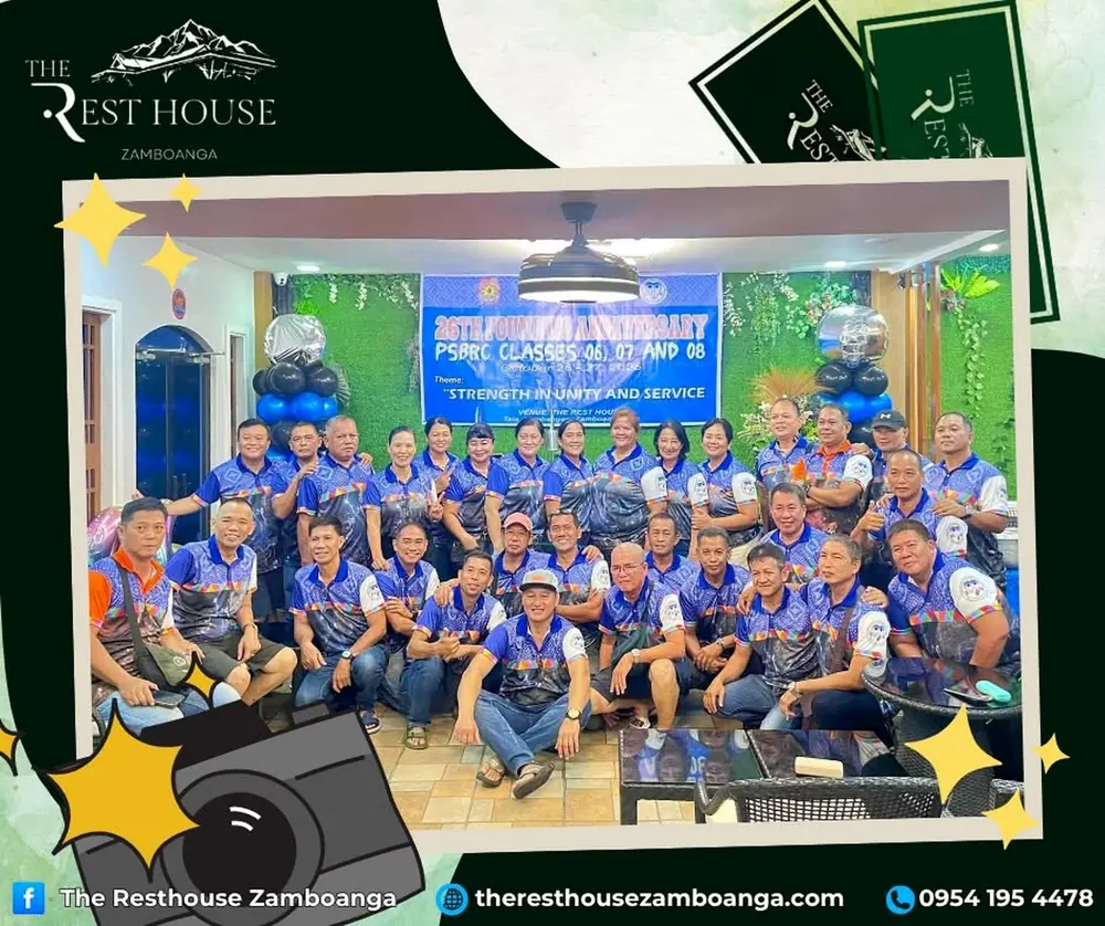 A large group in matching blue shirts at an anniversary reunion