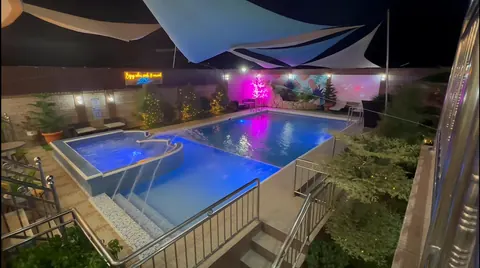 The swimming pool lit up at night